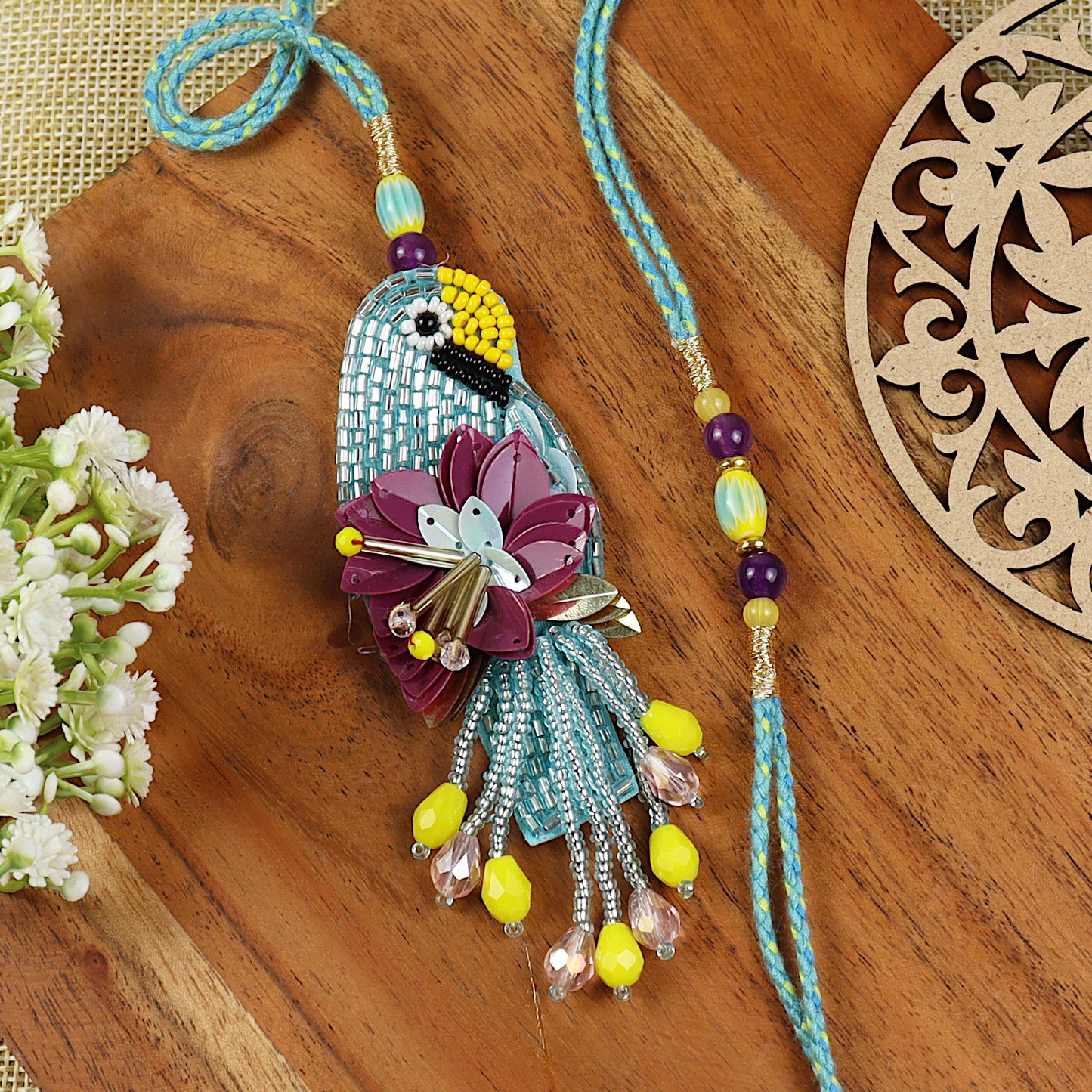 Hand Embroidered Parrot Bhai Bhabhi Rakhi pair — Rakhi and Lumba laid flat