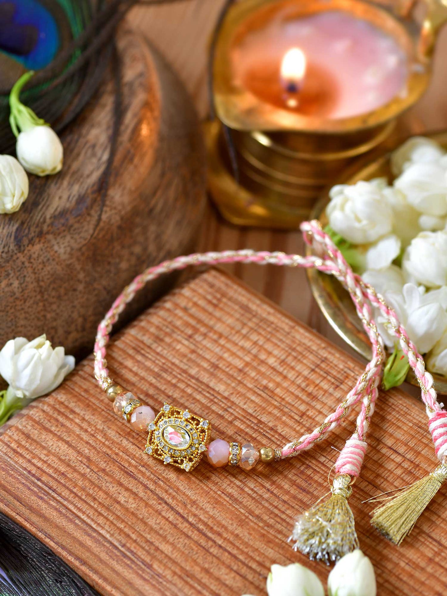 Zircon stone Rakhi with zircon stone studding on a thread cord