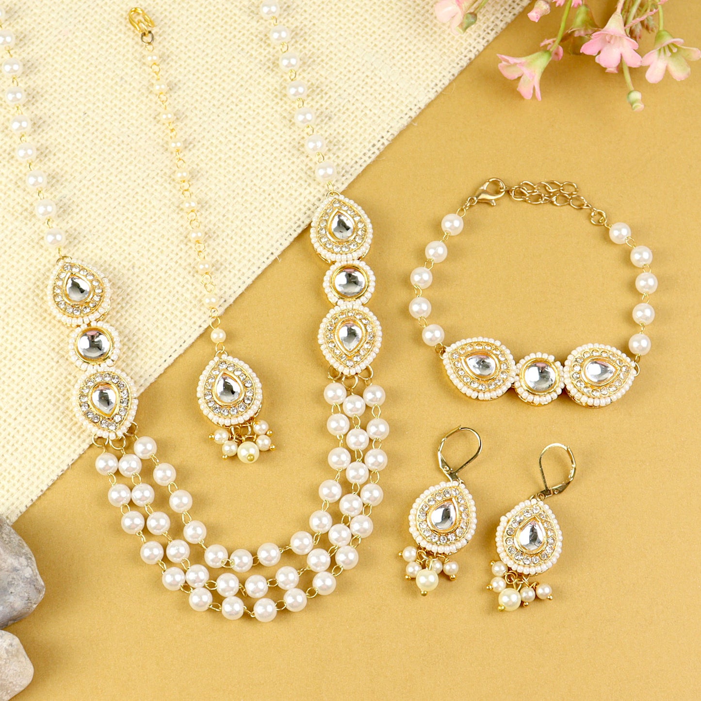 Kundan jewellery set for girls in gold-toned base, laid flat
