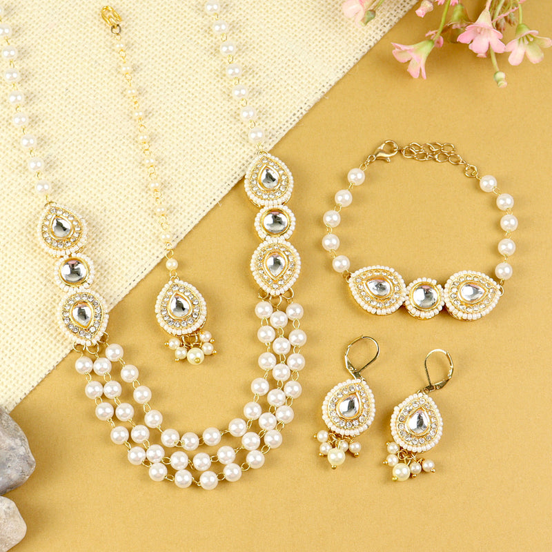 Kundan jewellery set for girls in gold-toned base, laid flat