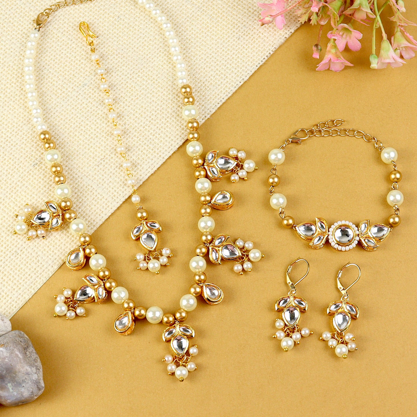 Kundan jewellery set for girls in gold-toned base, laid flat