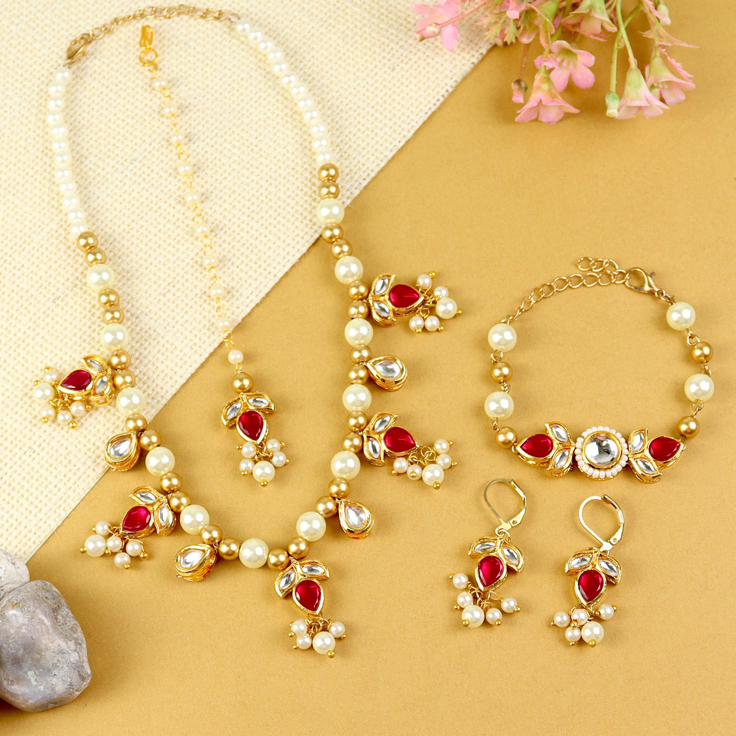 Kundan jewellery set for girls in gold-toned base, laid flat