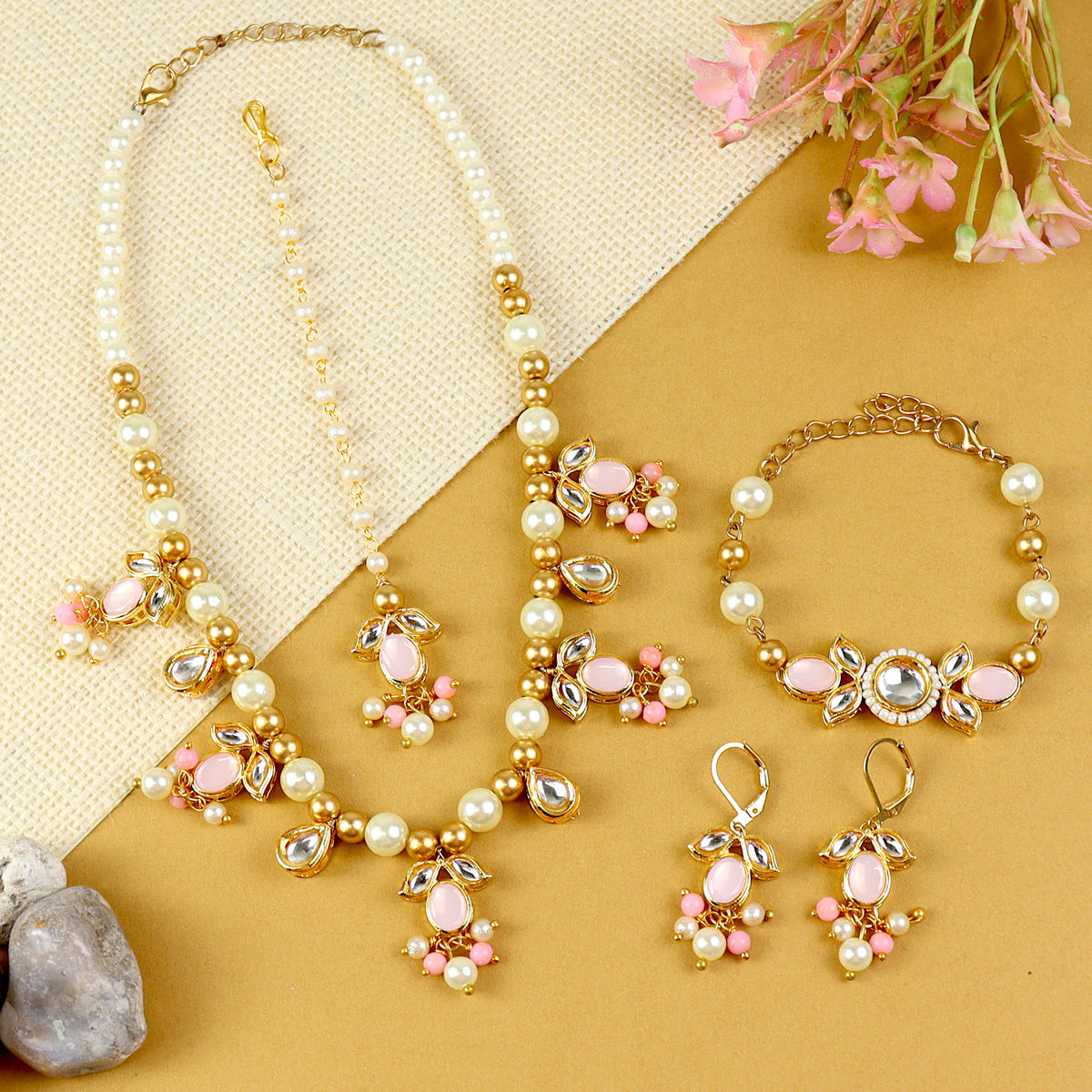 Kundan jewellery set for girls in gold-toned base, laid flat
