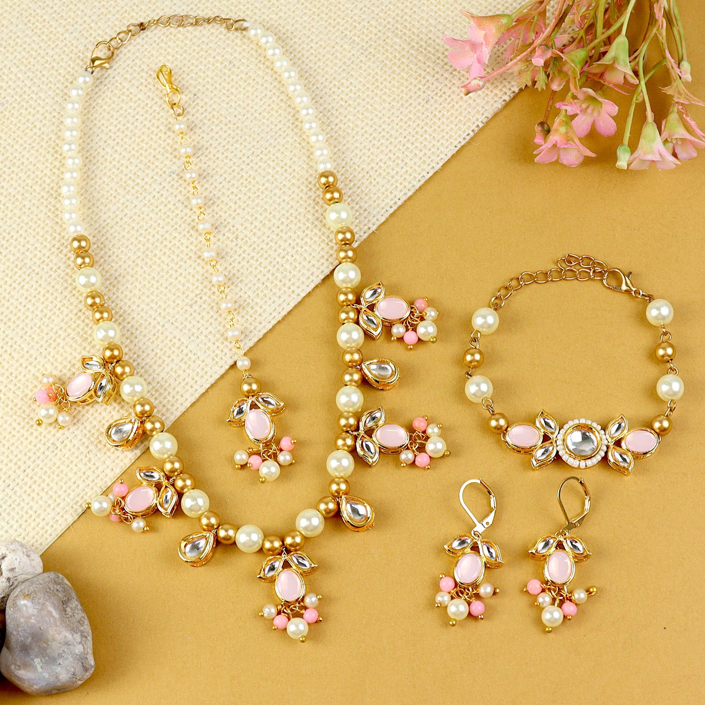 Kundan jewellery set for girls in gold-toned base, laid flat
