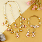 Kundan jewellery set for girls in gold-toned base, laid flat
