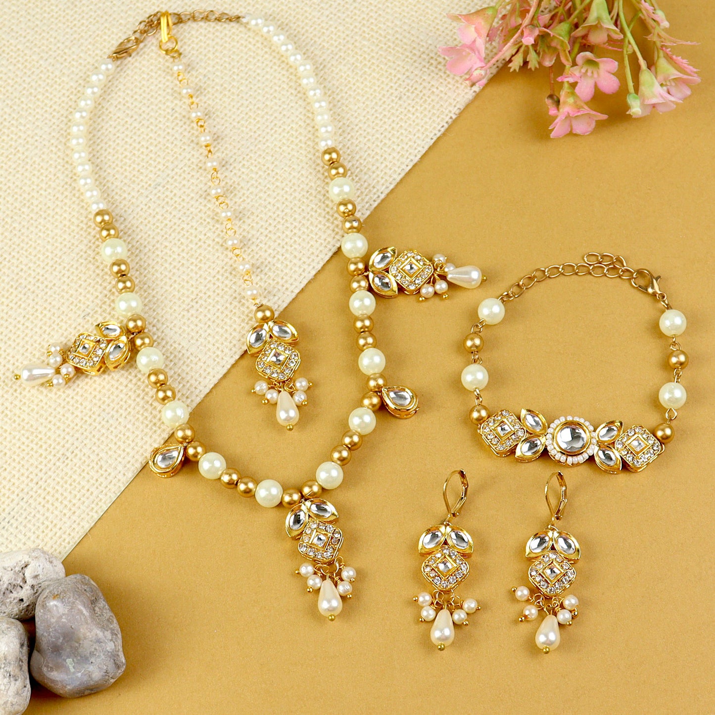 Kundan jewellery set for girls in gold-toned base, laid flat
