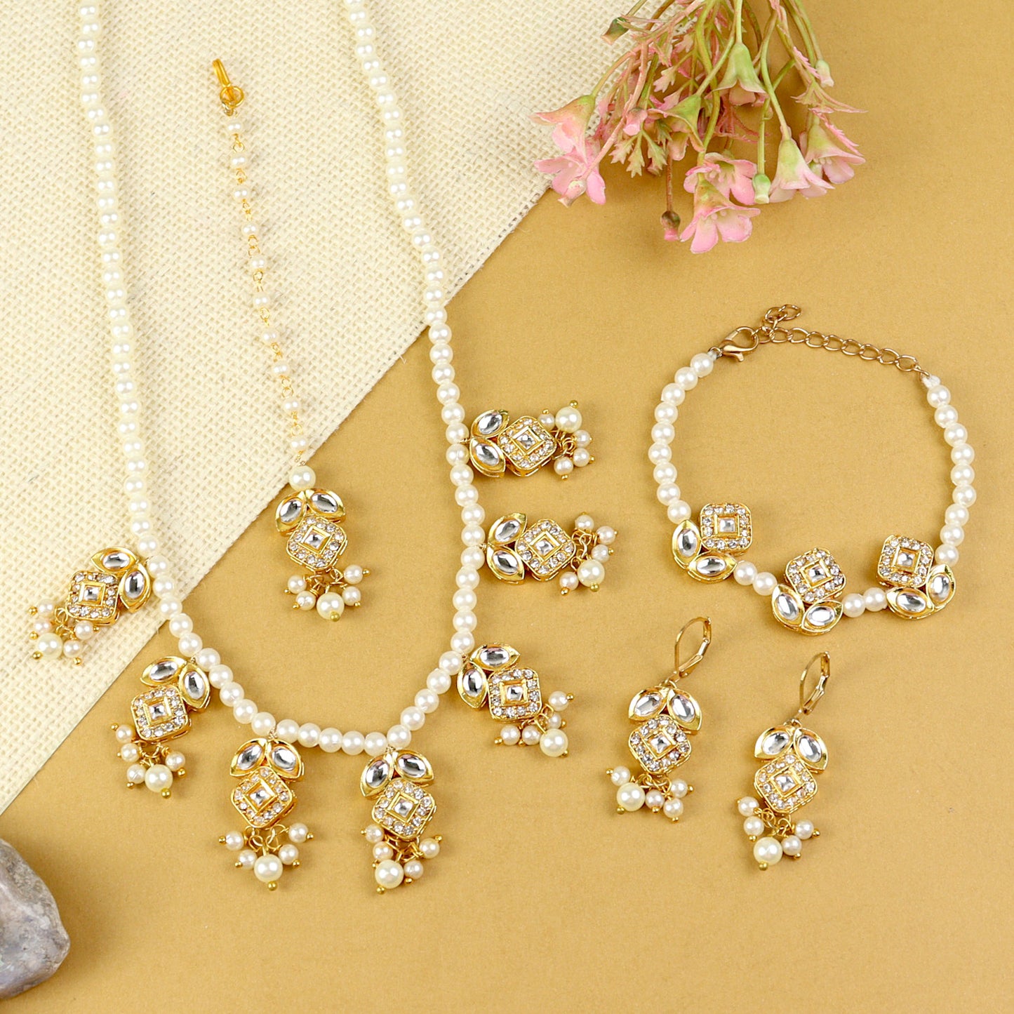 Kundan jewellery set for girls in gold-toned base, laid flat