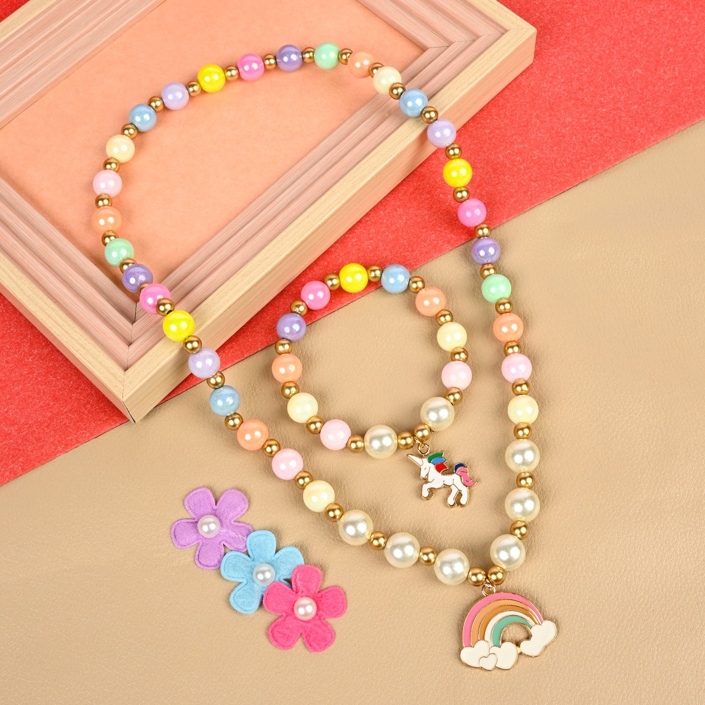 Unicorn rainbow charm necklace and bracelet set, laid flat
