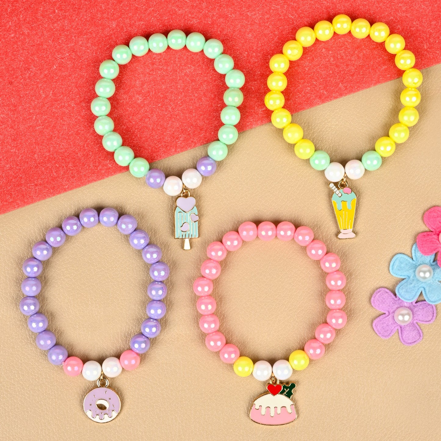 Set of 4 an ice-cream or donut charm beaded bracelets, laid flat