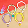 Set of 4 a floral charm beaded bracelets, laid flat