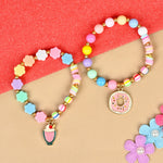 Set of 2 an ice-cream or donut charm beaded bracelets, laid flat