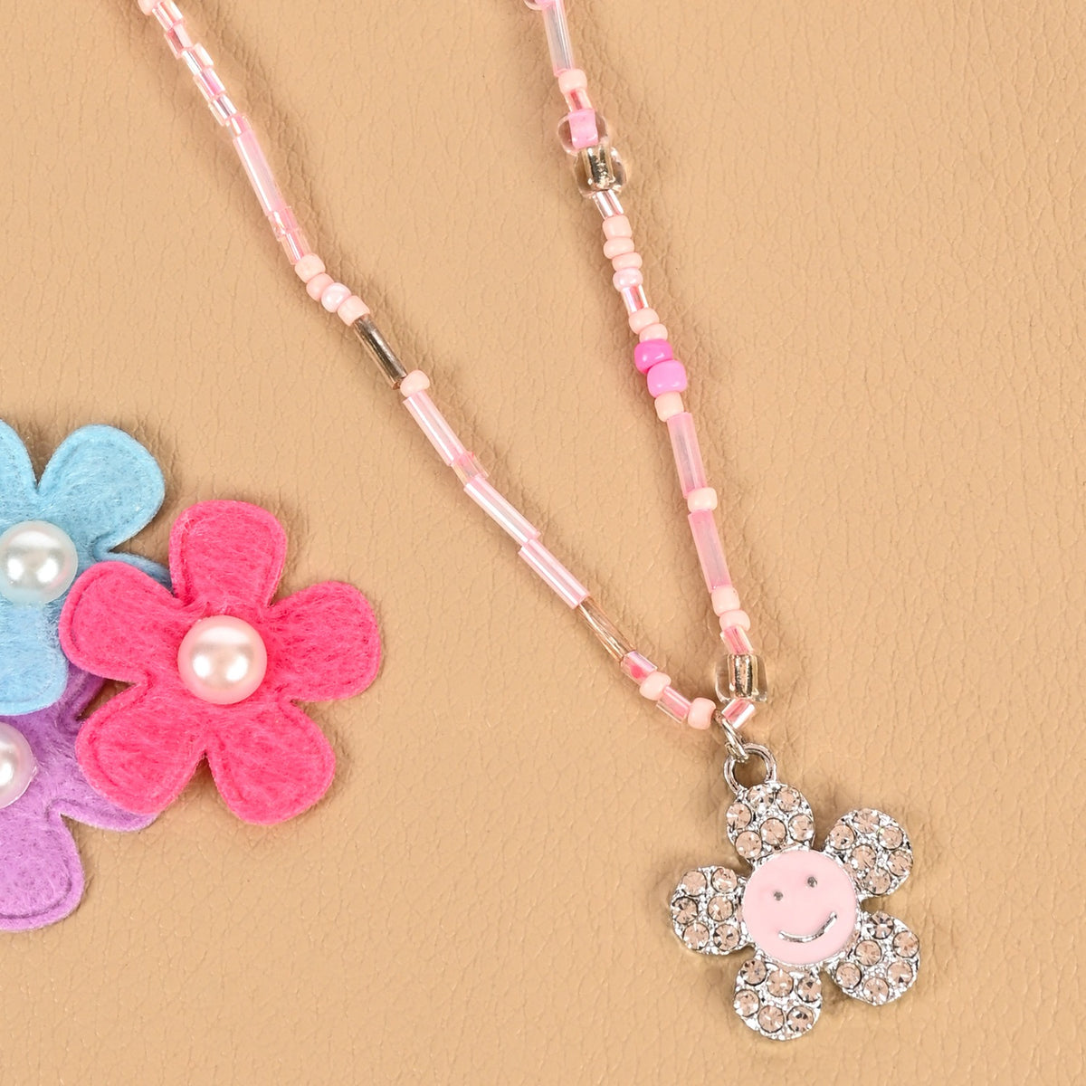 Smiley diamond charm necklace, laid flat