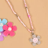 Smiley diamond charm necklace, laid flat