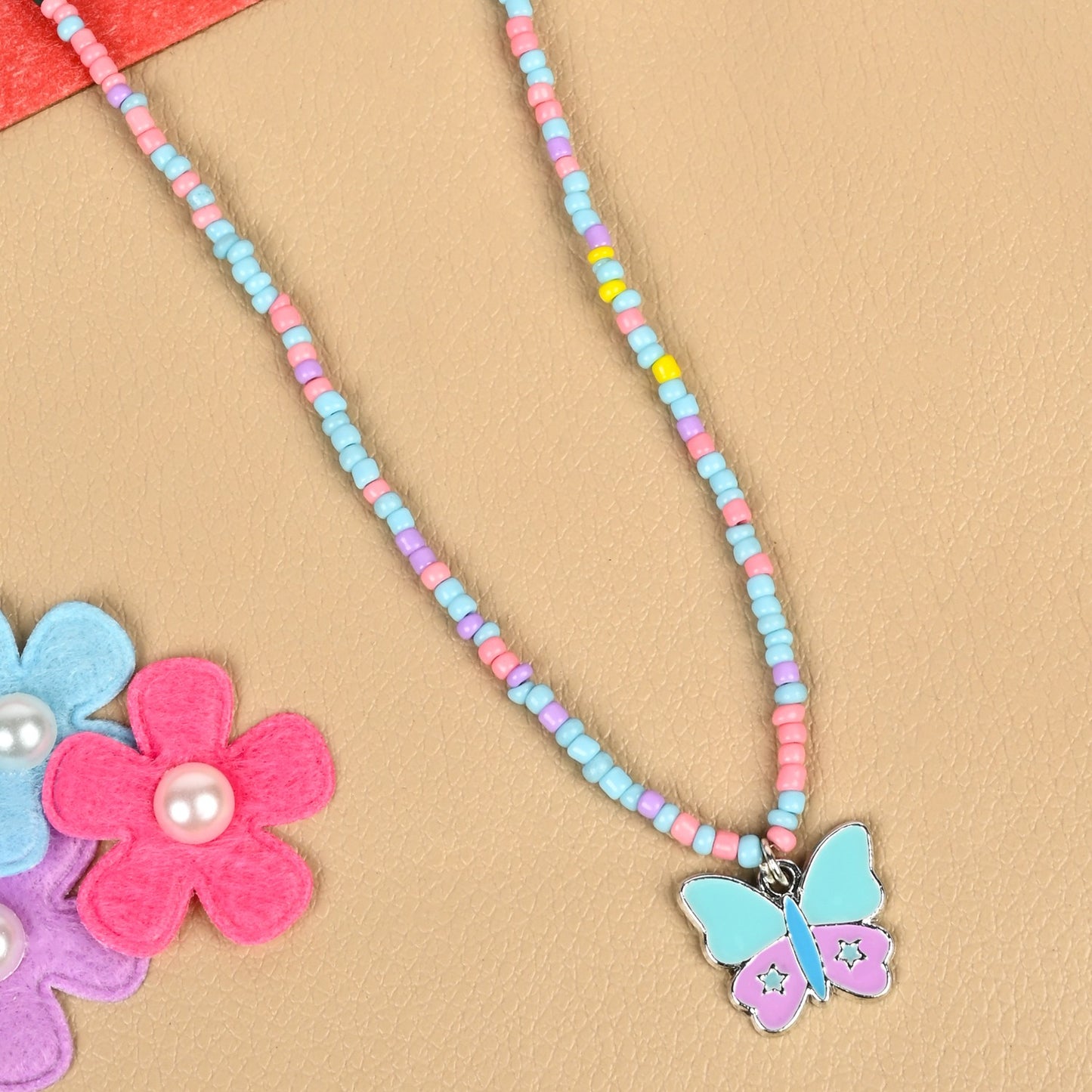 Butterfly charm necklace, laid flat