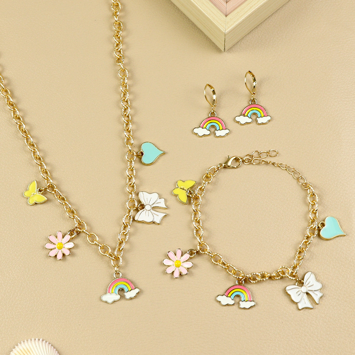 Multi Charm jewellery set for girls — necklace, bracelet, and earrings, laid flat