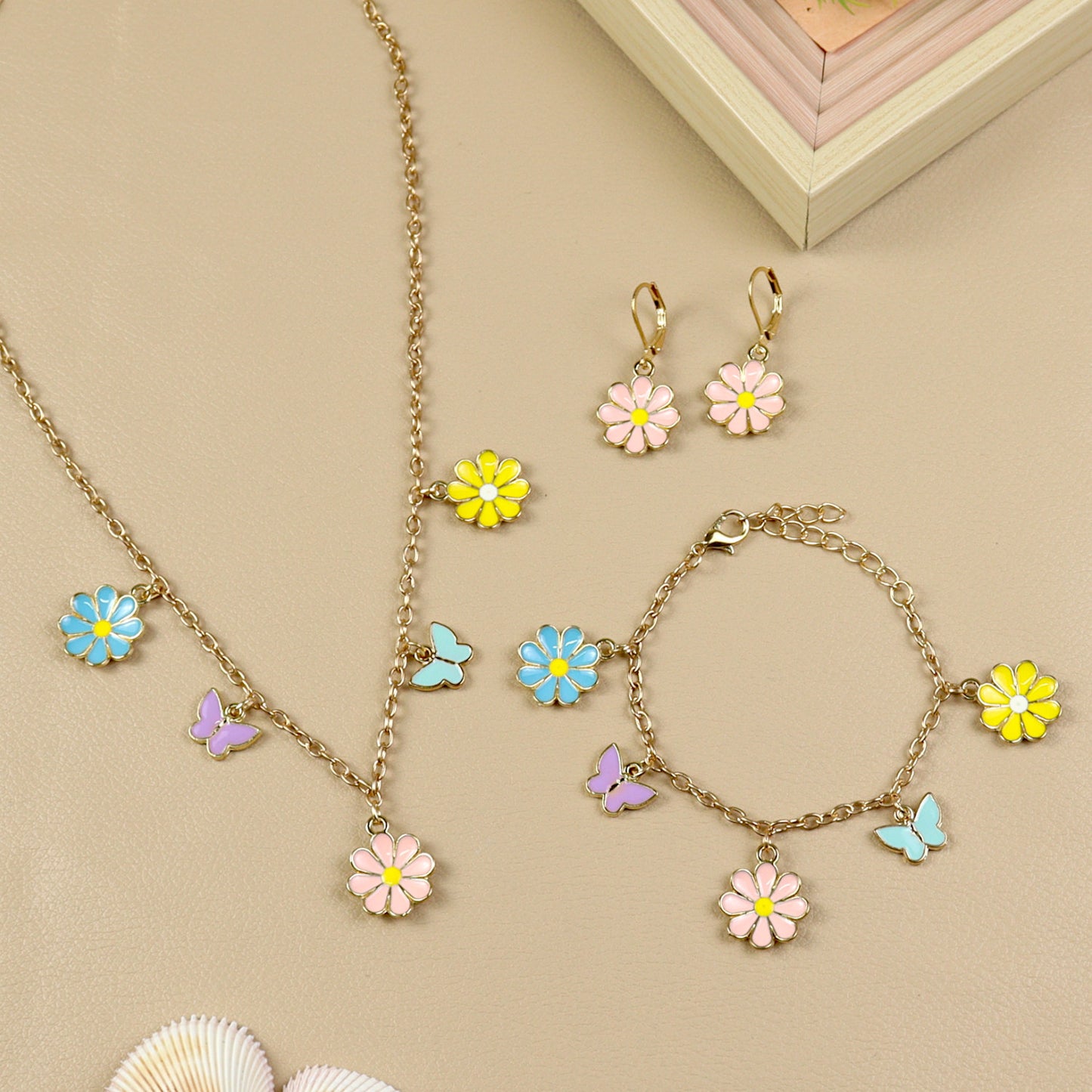 Multi Charm jewellery set for girls — necklace, bracelet, and earrings, laid flat