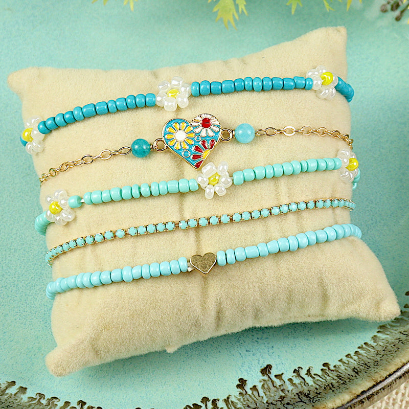 Set of 5 multi charm bracelets for girls, laid flat