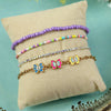 Set of 4 butterfly charm bracelets for girls, laid flat
