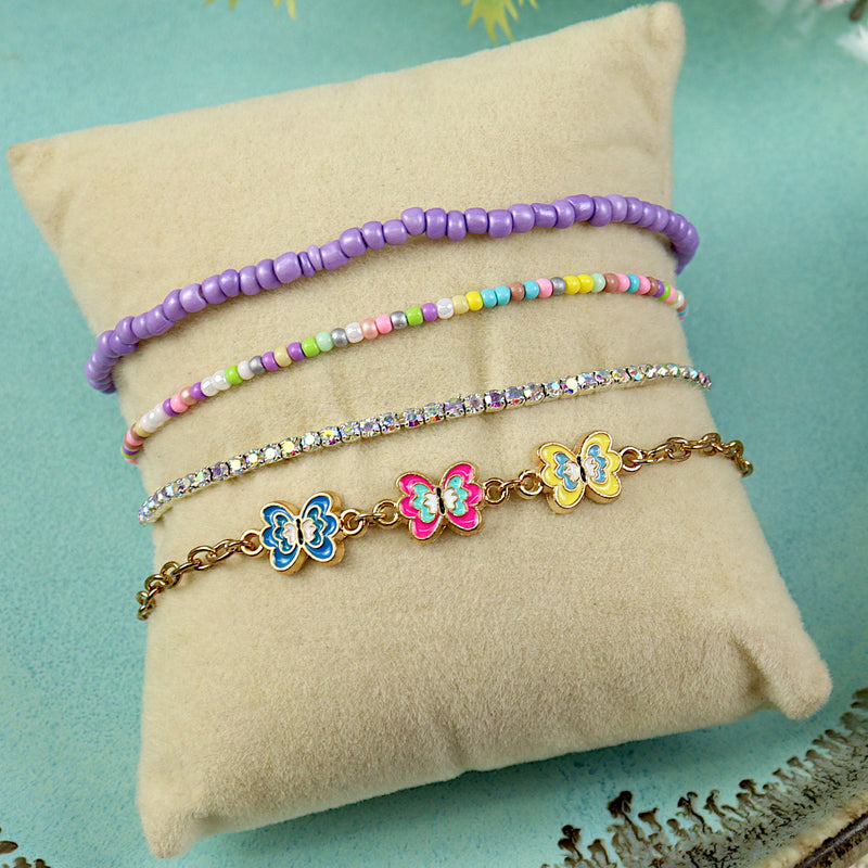 Set of 4 butterfly charm bracelets for girls, laid flat