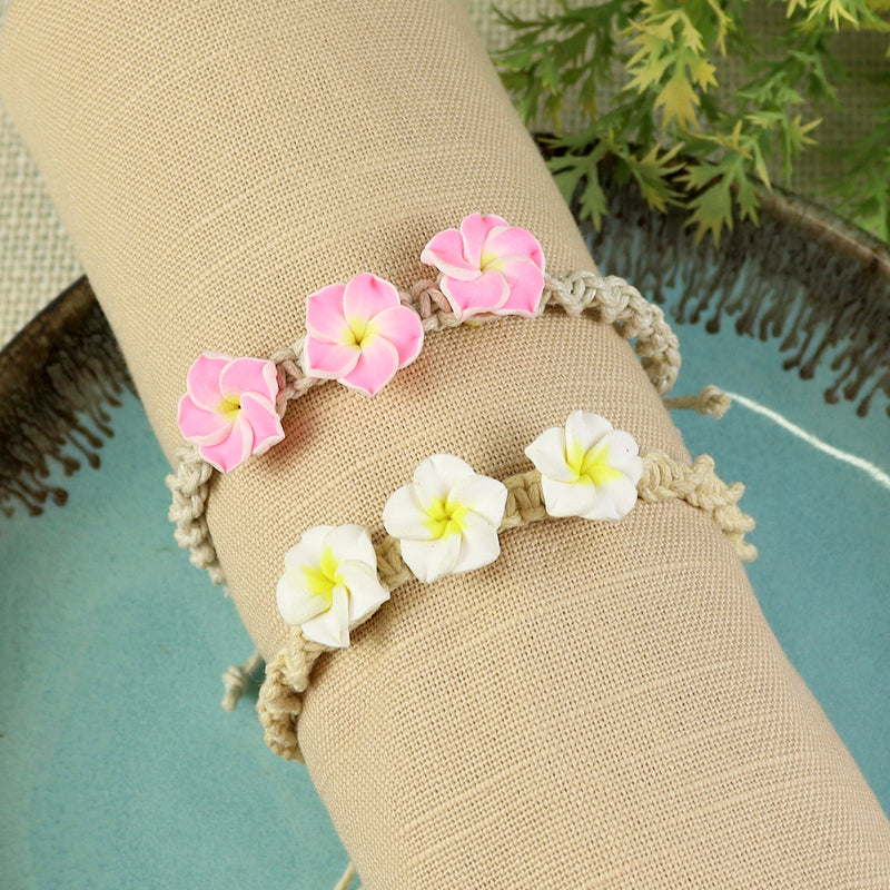 Set of 2 floral boho bracelets for girls in resin charms on woven thread, laid flat