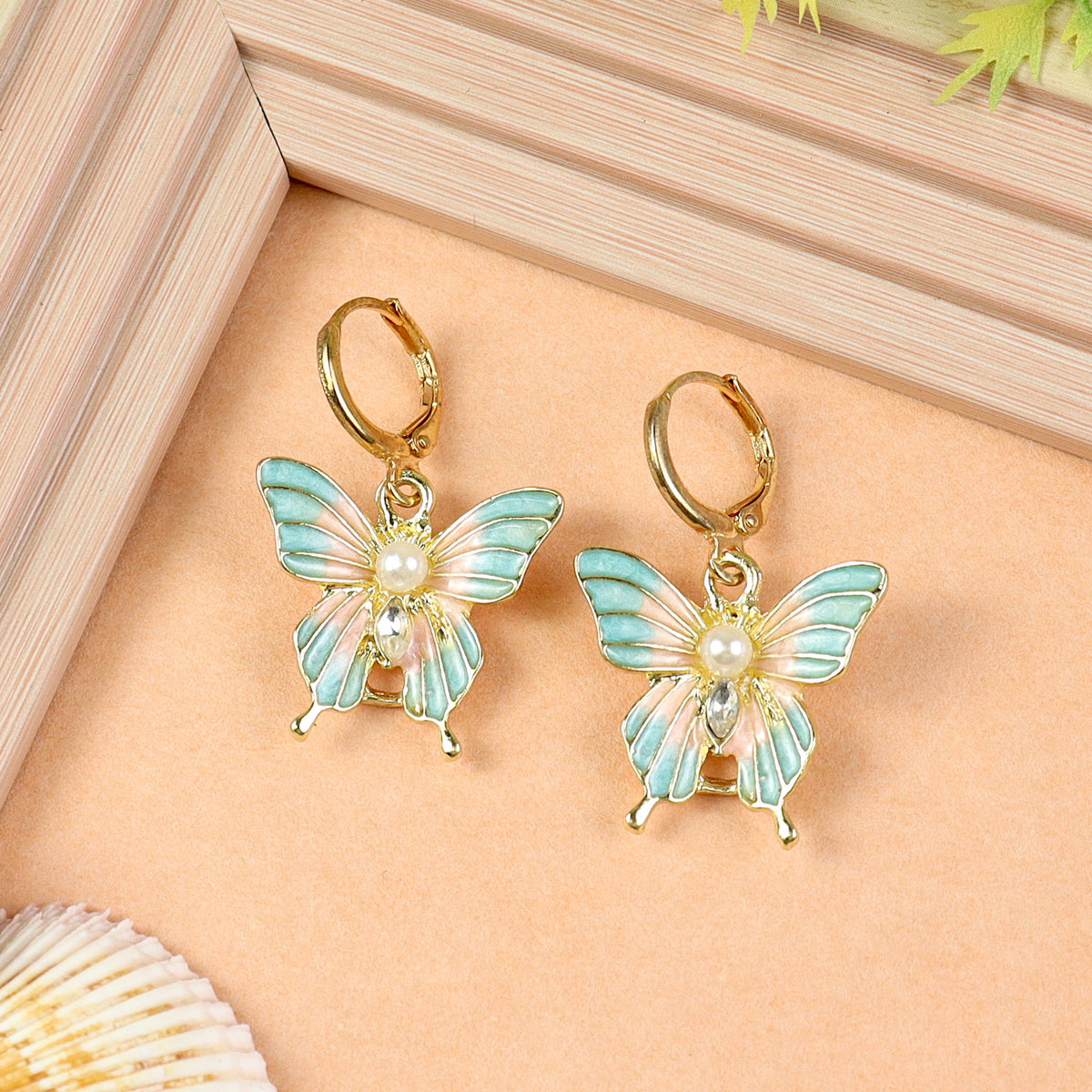 Butterfly Charm earrings for girls in metal charms, laid flat