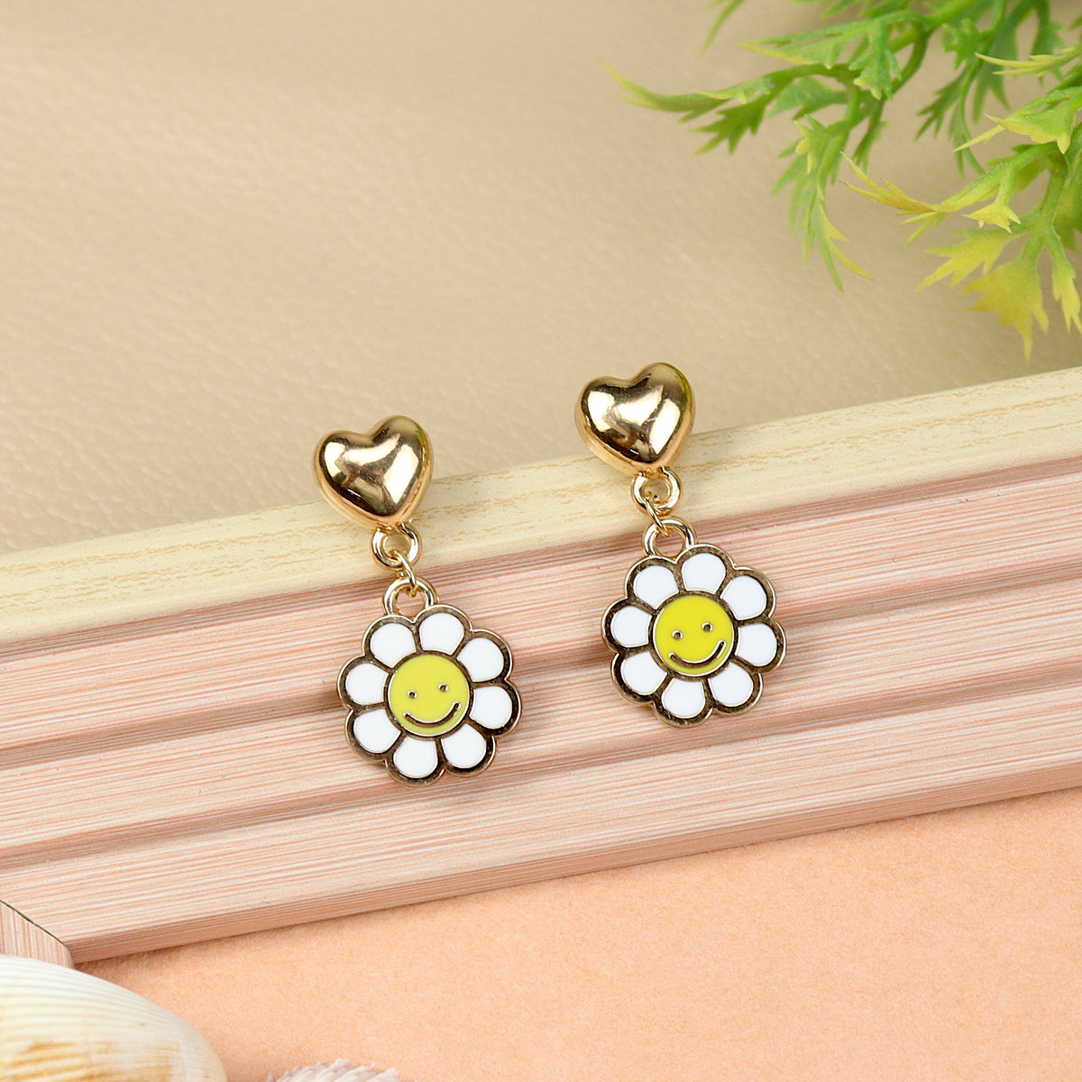Smiley Charm earrings for girls in metal charms, laid flat