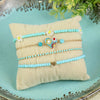 Set of 4 multi charm bracelets for girls, laid flat