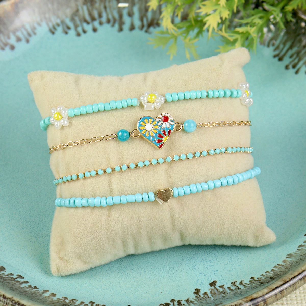 Set of 4 multi charm bracelets for girls, laid flat