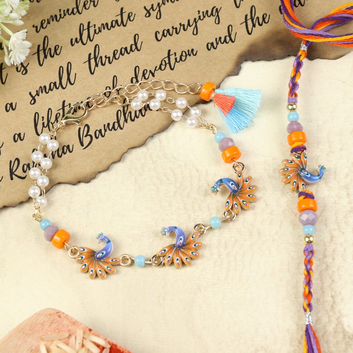 Peacock Tassel bracelet and Rakhi laid flat — Bhai Bhabhi Rakhi set