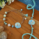 Floral Charm bracelet and Rakhi laid flat — Bhai Bhabhi Rakhi set