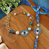 Evil Eye Charm bracelet and Rakhi laid flat — Bhai Bhabhi Rakhi set