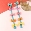Set of 2 bow tassel fabric hair clips, laid flat