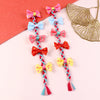 Two bow tassel fabric hair clips, laid flat