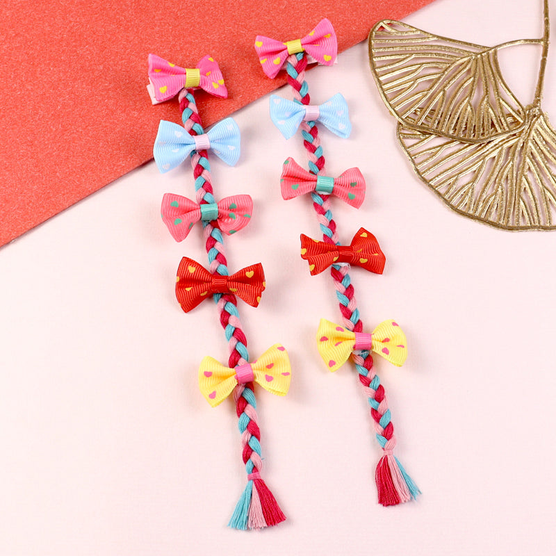 Two bow tassel fabric hair clips, laid flat