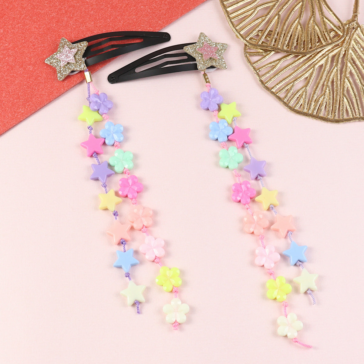 Set of 2 glitter star beaded tassel hair clips, laid flat