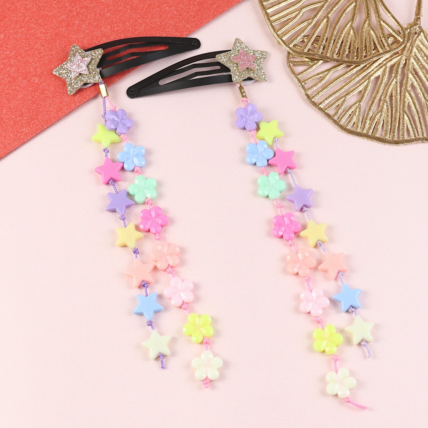 Set of 2 glitter star beaded tassel hair clips, laid flat