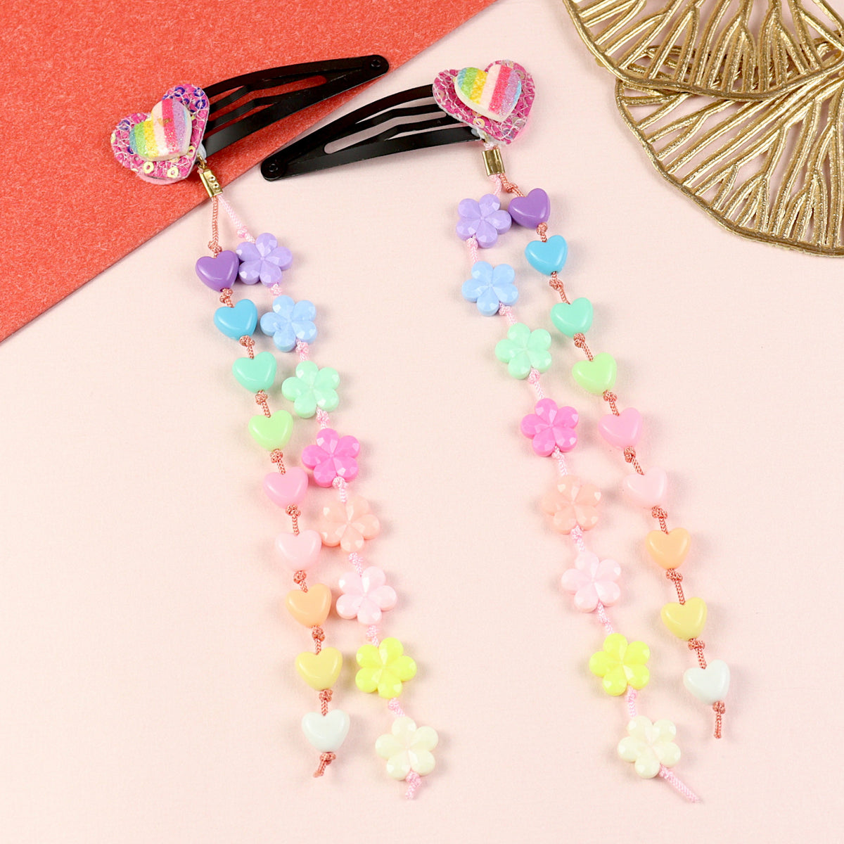 Set of 2 glitter heart beaded tassel hair clips, laid flat