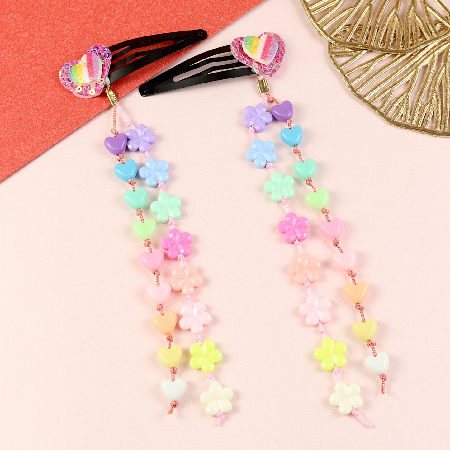 Set of 2 glitter heart beaded tassel hair clips, laid flat