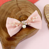 Bow charm fabric hair clip, laid flat