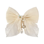 White Bow Tassels Hair Clip worn in hair, showing the tassel drop