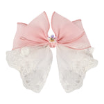 Pink Floral Charm Bow Hair Clip worn in hair, showing the floral charm on the bow