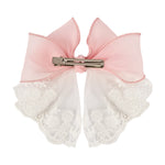 Close-up of the floral charm on the bow on the pink clip