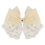 White Floral Charm Bow Hair Clip worn in hair, showing the floral charm on the bow