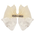 Close-up of the floral charm on the bow on the white clip