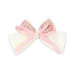 Pink Floral Charm Bow Hair Clip worn in hair, showing the floral charm on the bow