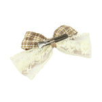 Close-up of the floral charm on the bow on the brown clip