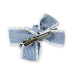Close-up of the floral charm on the bow on the blue clip