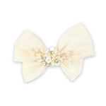 White Floral Charm Bow Hair Clip worn in hair, showing the floral charm on the bow