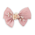 Pink Floral Charm Bow Hair Clip worn in hair, showing the floral charm on the bow