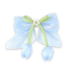 Blue Floral Charm Bow Hair Clip worn in hair, showing the floral charm on the bow
